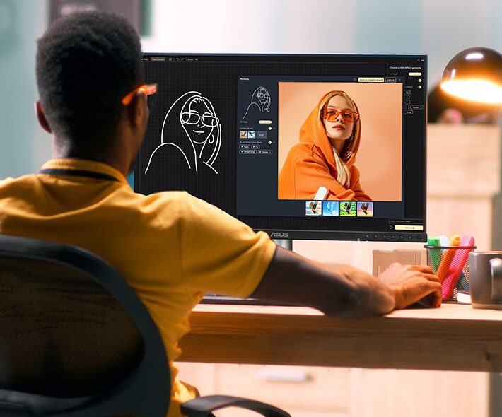 An AI artist is using a ProArt Display PA27JCV to create a digital painting of a woman wearing a bright orange hoodie.