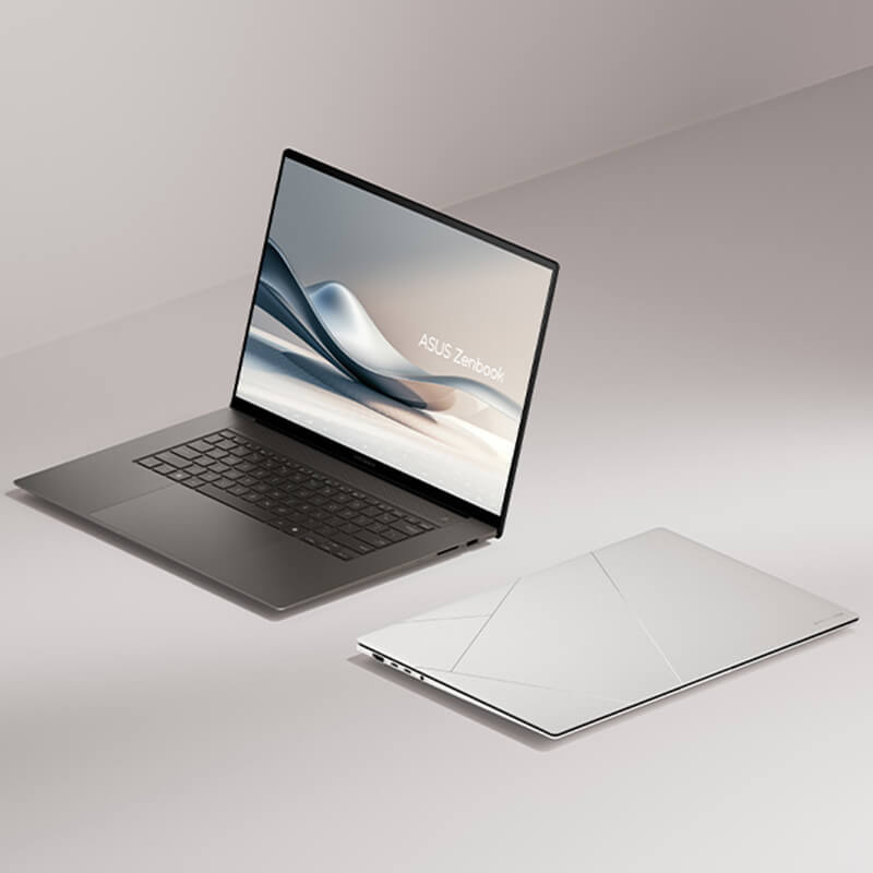 Two Zenbook S 16 laptops opened at 100 degrees and viewed from the left front, while the other one is closed and placed on the ground.