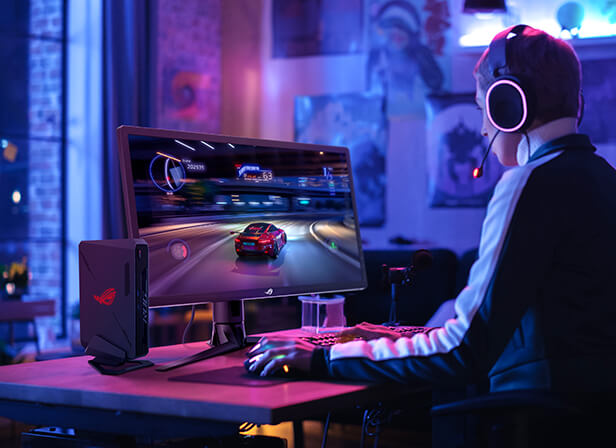A gamer wearing headphones and playing an HDR game on a high-performance desktop computer setup.