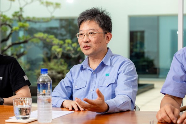 Chen Xin-zhi, GM of San Shing Fastech Corp taking interview, wearing blue uniform shirt.