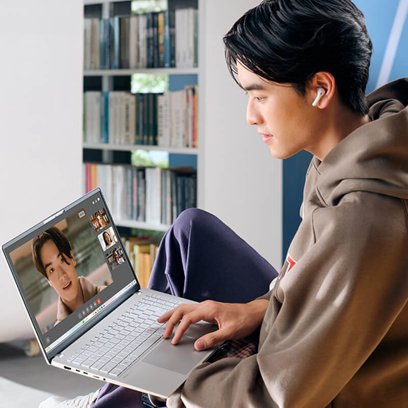 A young man uses ASUS Vivobook S 15 laptop for videoconferencing.