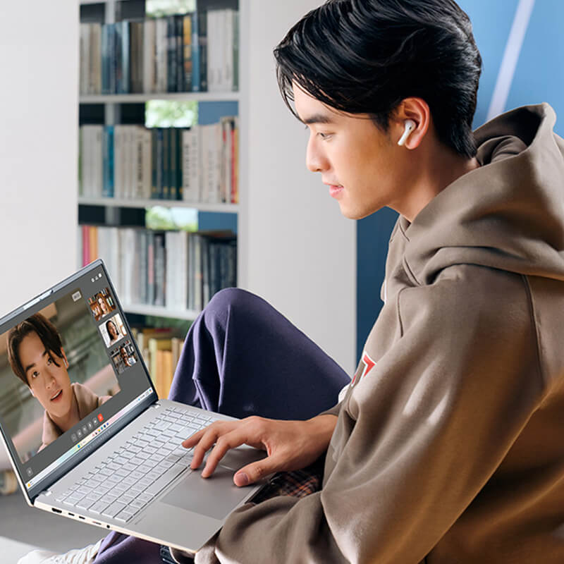 A young man uses ASUS Vivobook S 15 laptop for videoconferencing.