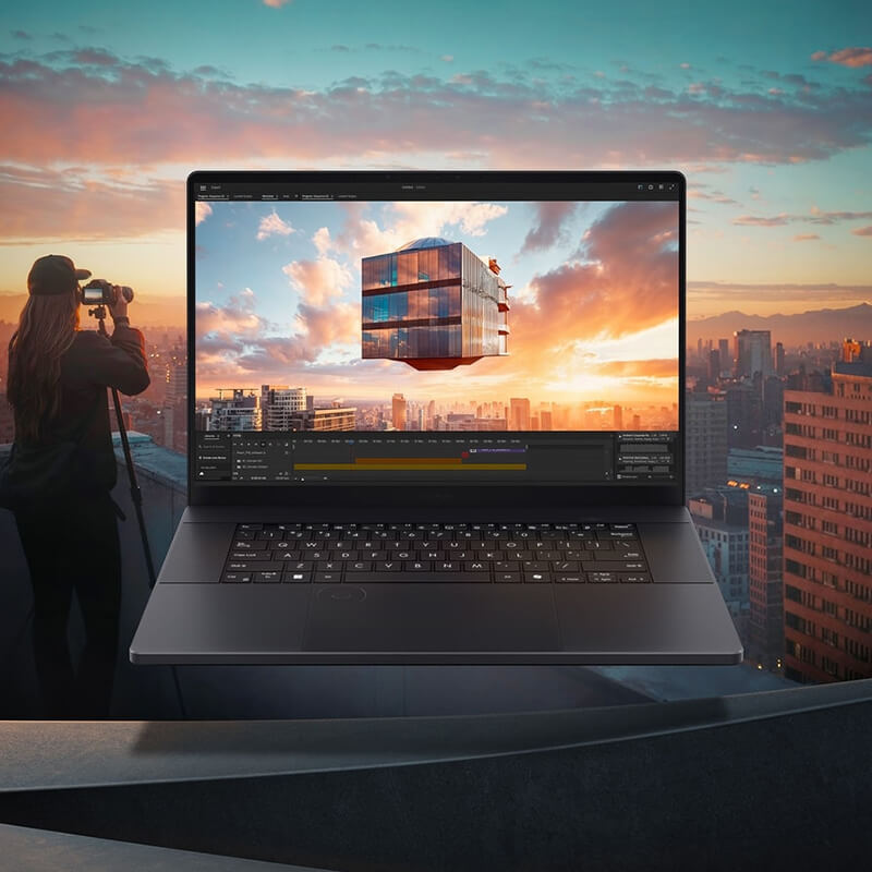 ProArt P16 laptop open with a video editing software window on screen and a city during sunset in the background.