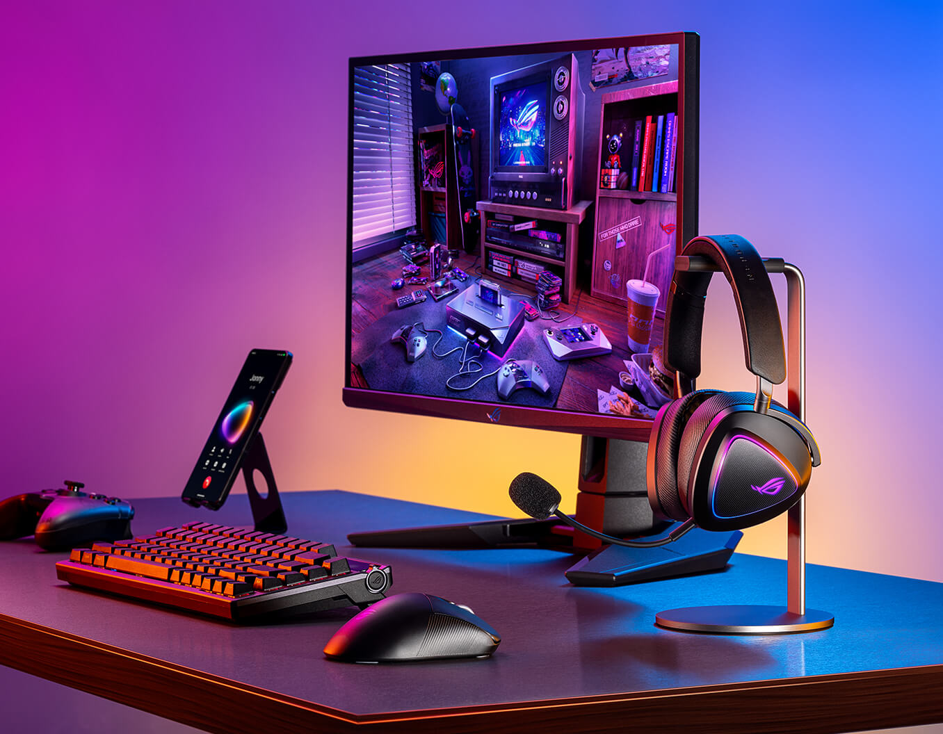 A gaming setup on a desk with a monitor. In front of the monitor are a ROG keyboard, a gaming mouse, and a ROG phone. To the right of the monitor, a gaming headset with a glowing logo is placed on a sleek headset stand. The background features a gradient of purple and orange lighting, creating a vibrant and immersive atmosphere.