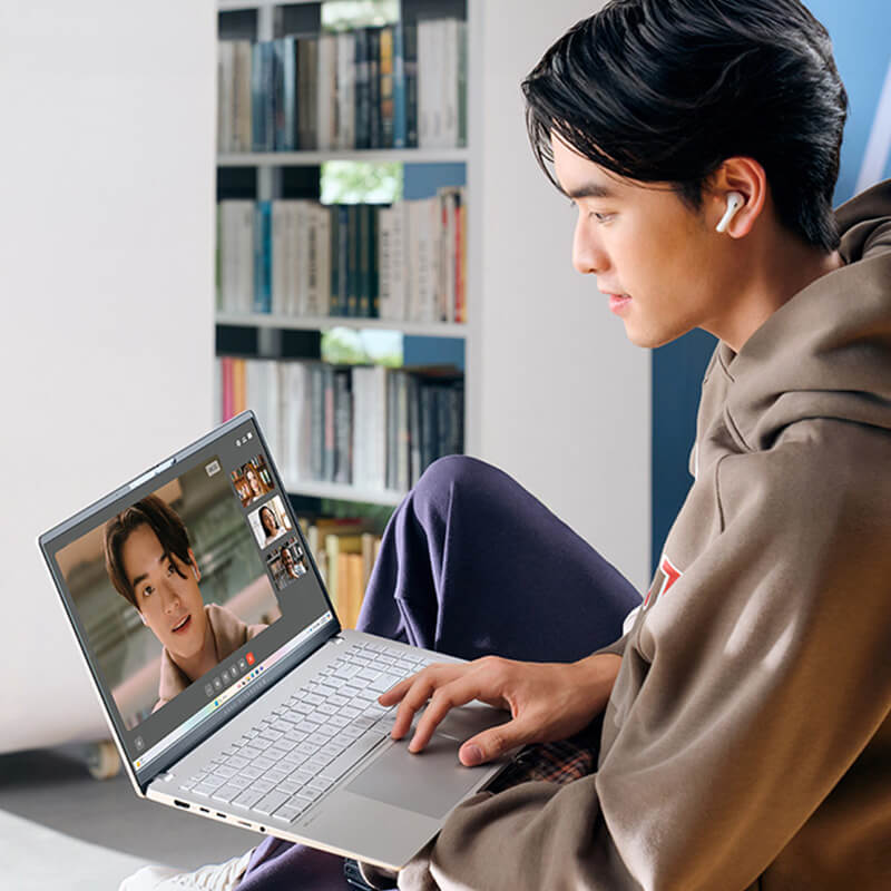 A young man uses ASUS Vivobook S 15 laptop for videoconferencing.