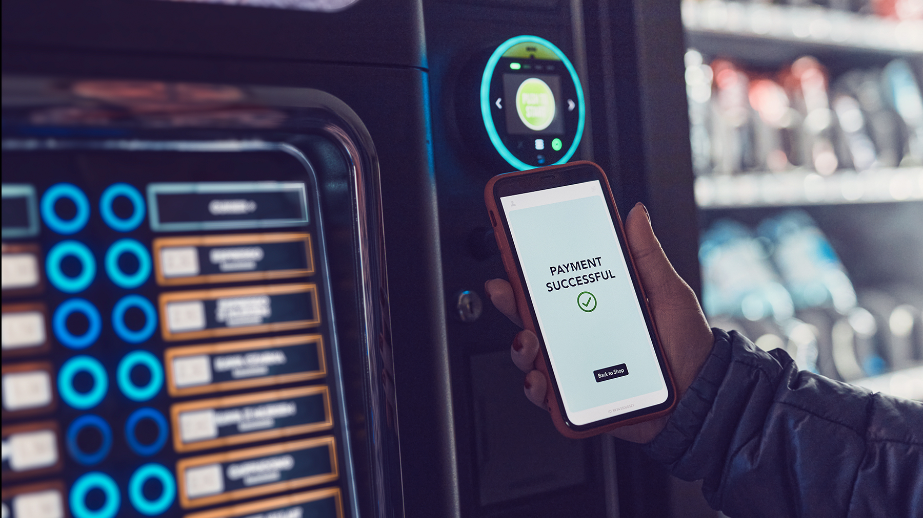  A smart phone is making payment in front of a smart vending machine.