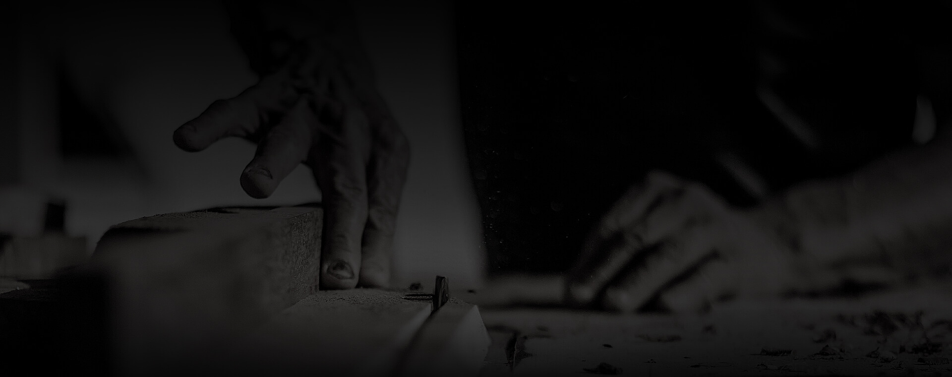 a craftman's hands crafting the wood